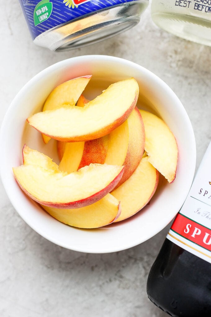 Sliced peaches in a small bowl.