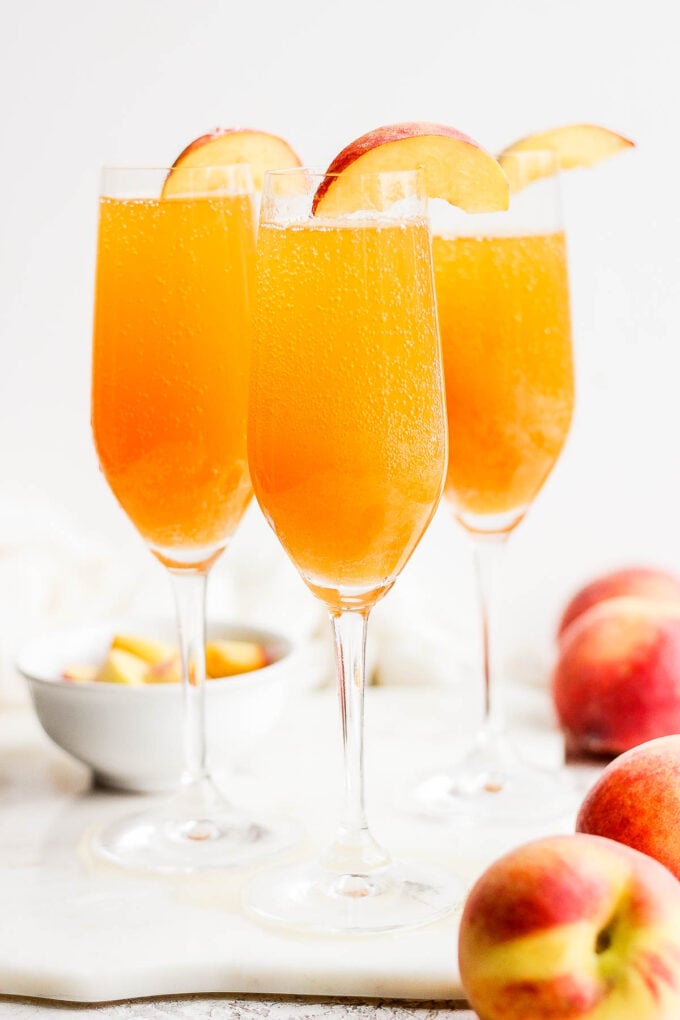 Peach cocktail in a champagne flute.