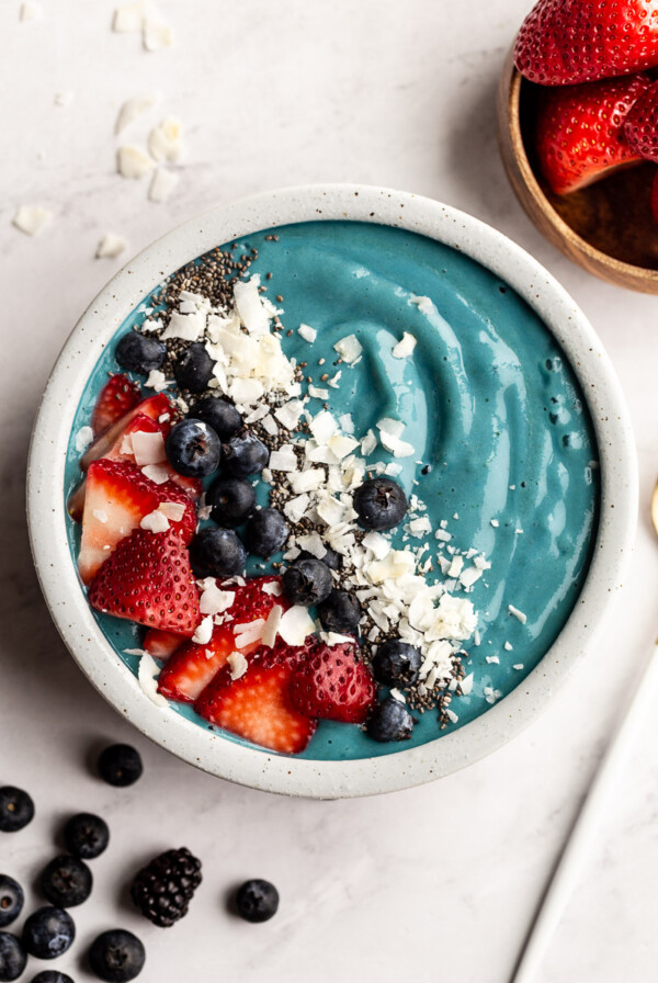 Blue Spirulina Smoothie bowl topped with fresh fruit.