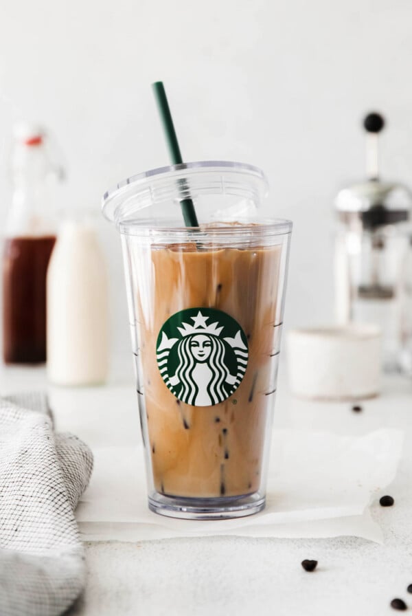 ice brown sugar latte in a starbucks cup with the lid hanging off the side