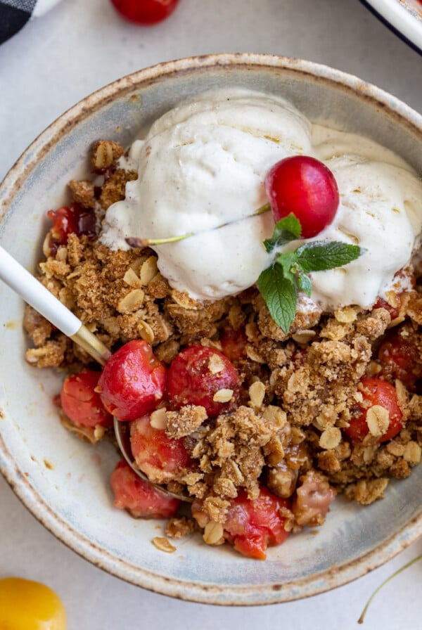 cherry crisp served with vanilla ice cream