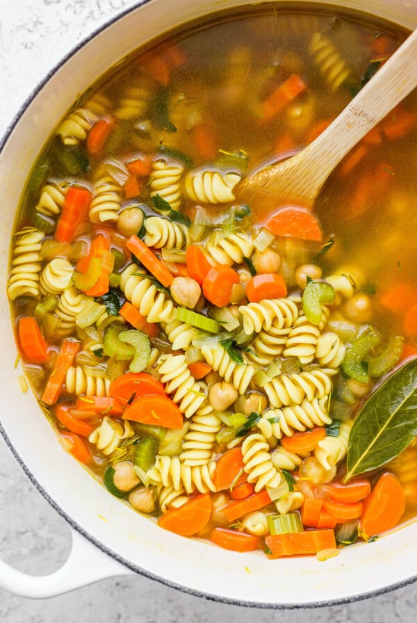 Chickpea noodle soup cooking in a large pot.