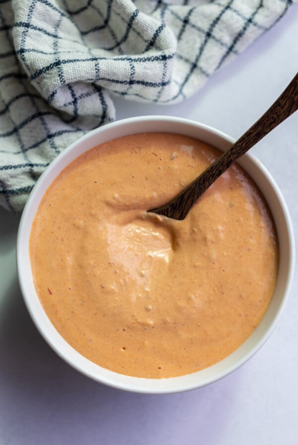 chipotle mayo in a large white bowl with a spoon