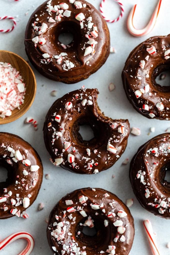 top down shot of chocolate donuts with a chocolate frosting and crushed peppermint on top