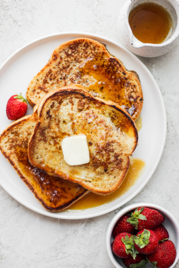 Cinnamon French Toast topped with butter and maple syrup.