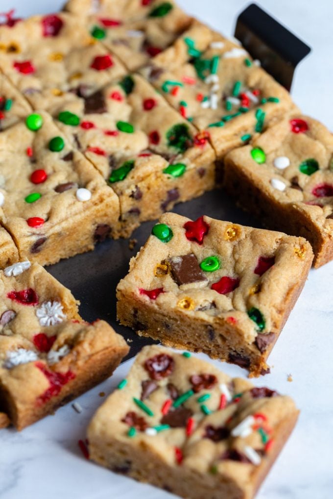 chocolate chip cookie bars with red and green and white sprinkles. cut in squares