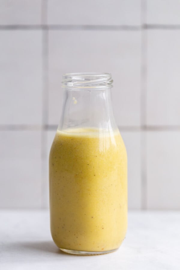 creamy garlic dressing in a small glass jar