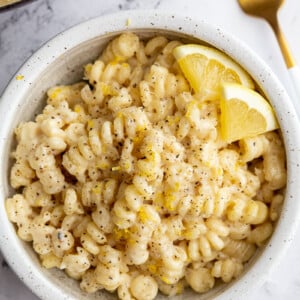 Creamy lemon pasta served in a white bowl.