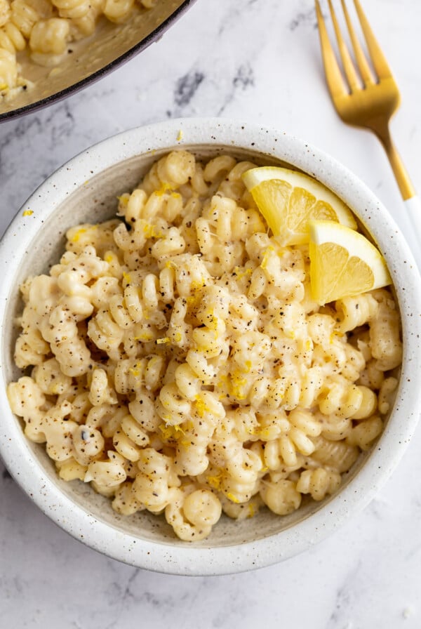 Creamy lemon pasta served in a white bowl.