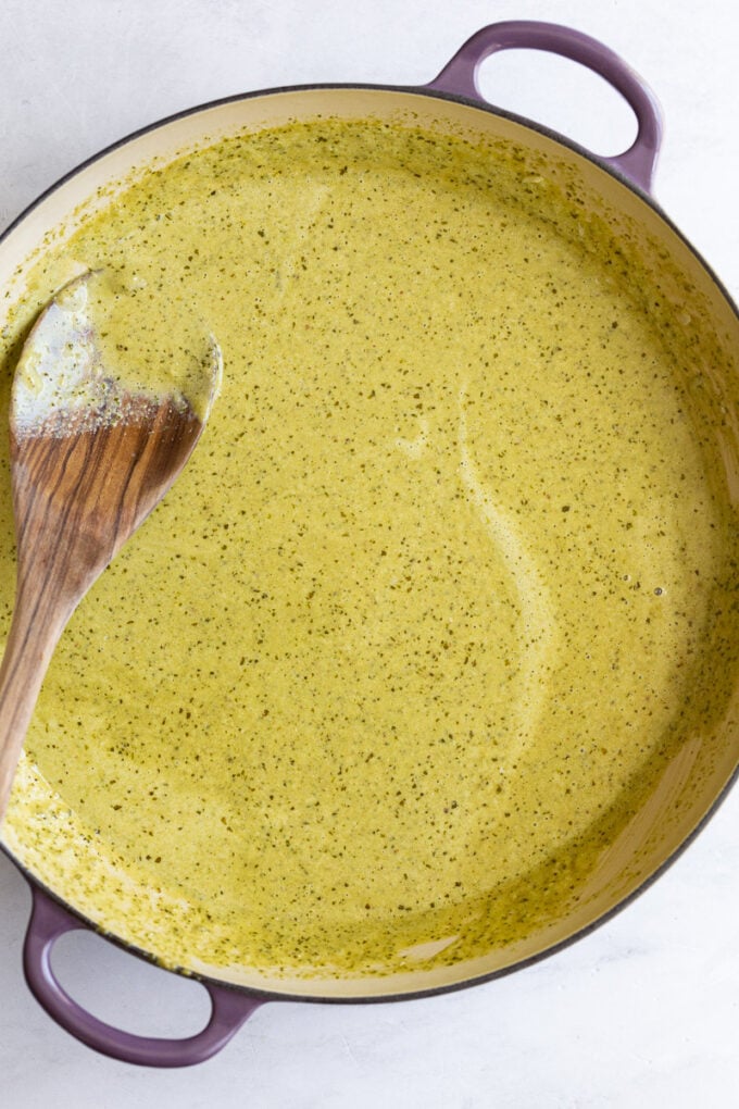 Creamy pesto sauce in a large pot.