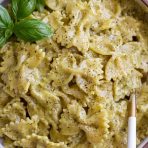 Pesto cream sauce pasta in a bowl.