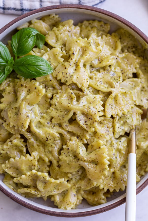 Pesto cream sauce pasta in a bowl.