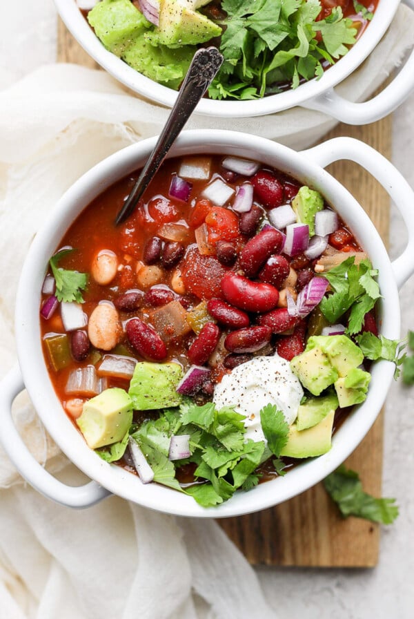 vegan crockpot chili in a white bowl with a spoon