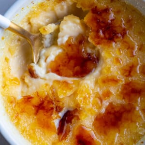 A spoon in a small bowl with Crème Brûlée.