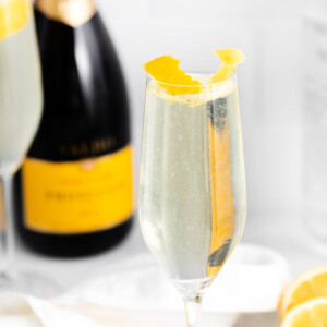 French 75 drink near a bottle of champagne