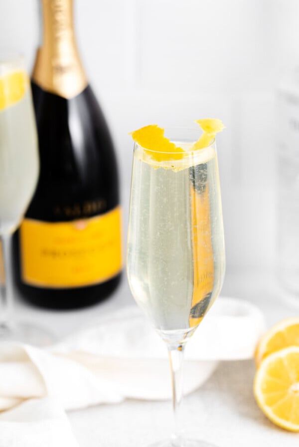 French 75 drink near a bottle of champagne