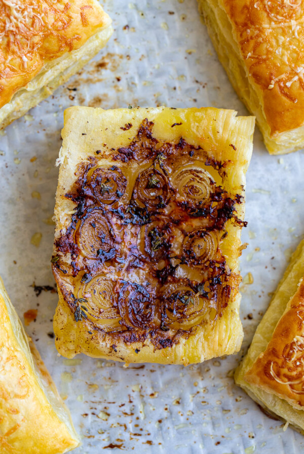 french onion tarts on a baking tray lined with parchment paper