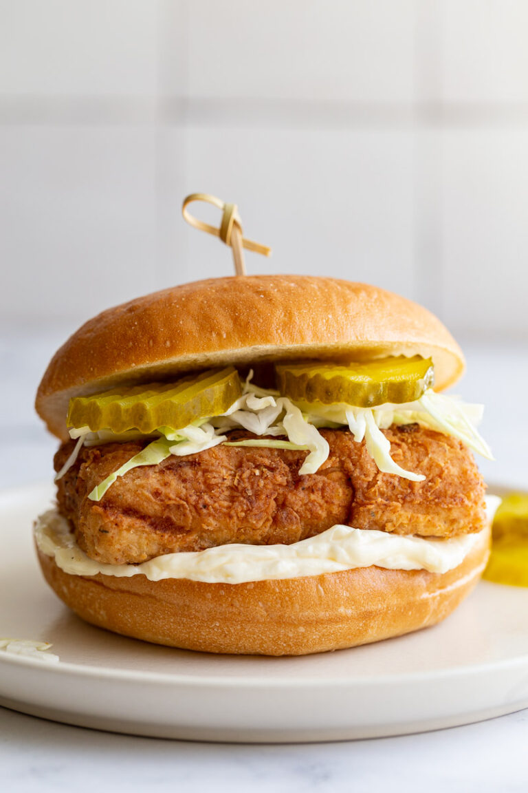 tofu "chicken sandwich on a bun with mayo, cabbage and pickles and a toothpick in the center