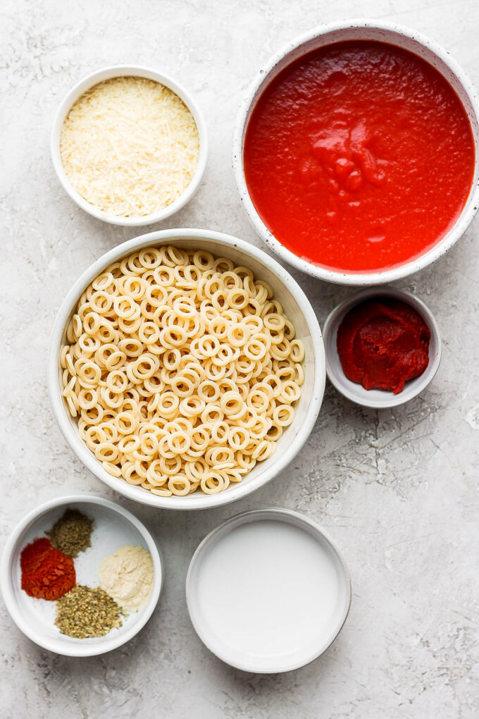 Ingredients for making homemade spaghettios divided into small bowls.