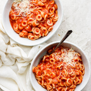 Two white bowls filled with homemade spaghettios.