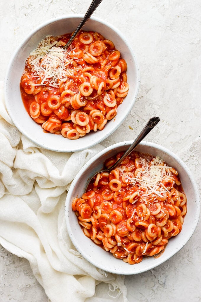 Two white bowls filled with homemade spaghettios.