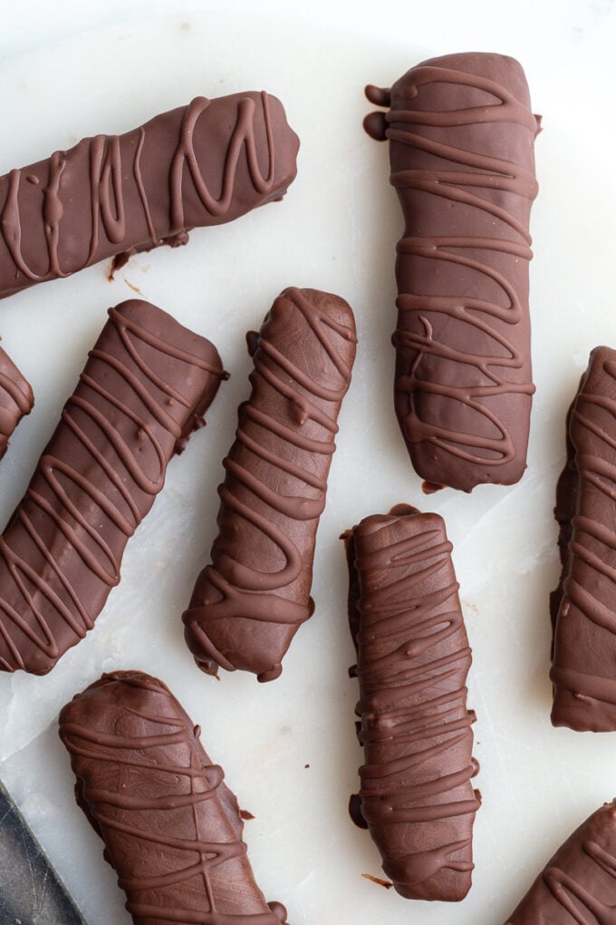 top down shot of homemade twix chocolate bars. There's extra chocolate drizzled on top of them in a swirled pattern