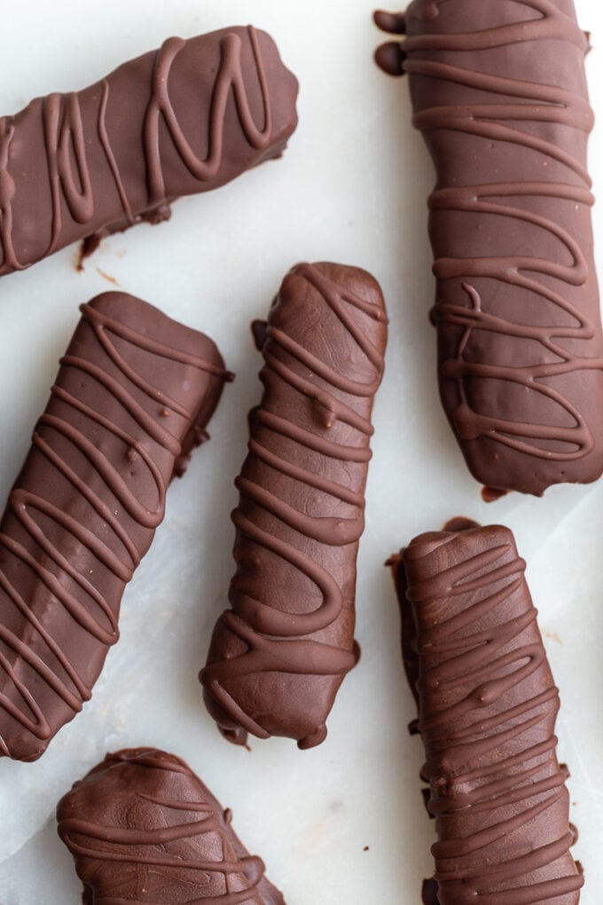 top down shot of homemade twix chocolate bars. There's extra chocolate drizzled on top of them in a swirled pattern