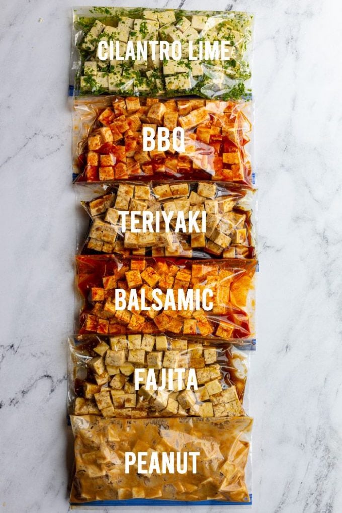 6 different bags of tofu marinating labeled each with it's flavor including: cilantro lime, bbq, teriyaki, balsamic, fajita, peanut