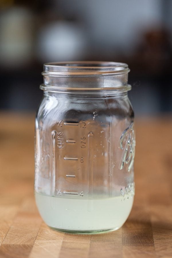 mason jar filled with about 1/2 cup of excess liquid from a block of tofu