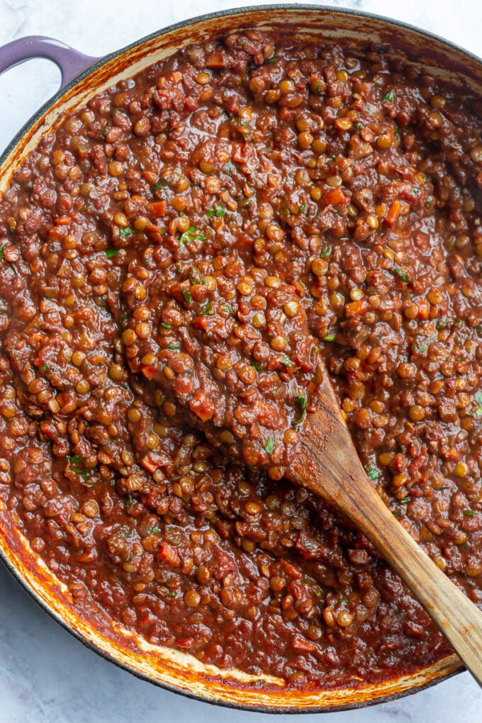 Lentil Bolognese on a wooden spoon.