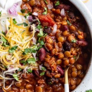 lentil chili topped with cheese, sour cream and fresh cilantro