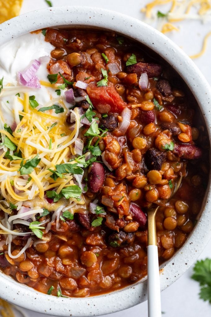 lentil chili topped with cheese, sour cream and fresh cilantro