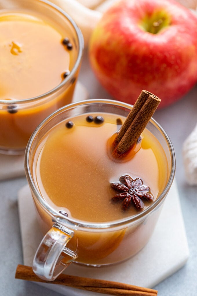 Mulled cider served with a cinnamon stick.