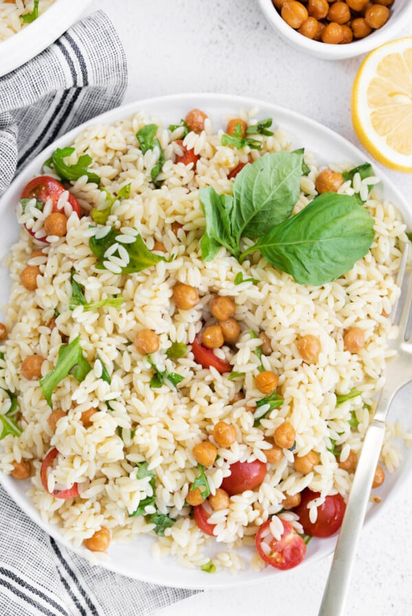 orzo pasta salad topped with chickpeas and tomatoes