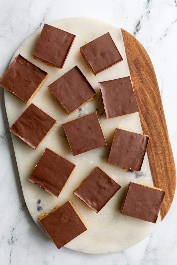 chocolate peanut butter bars sitting on a marble board