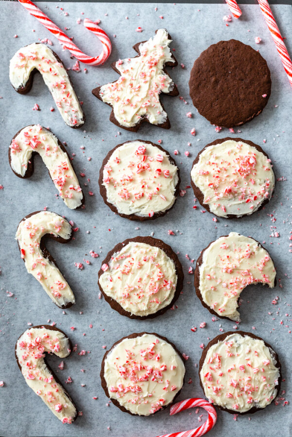 sheet pan filled with chocolate cut out cookies and tppped with a vanilla frosting and crushed peppermint