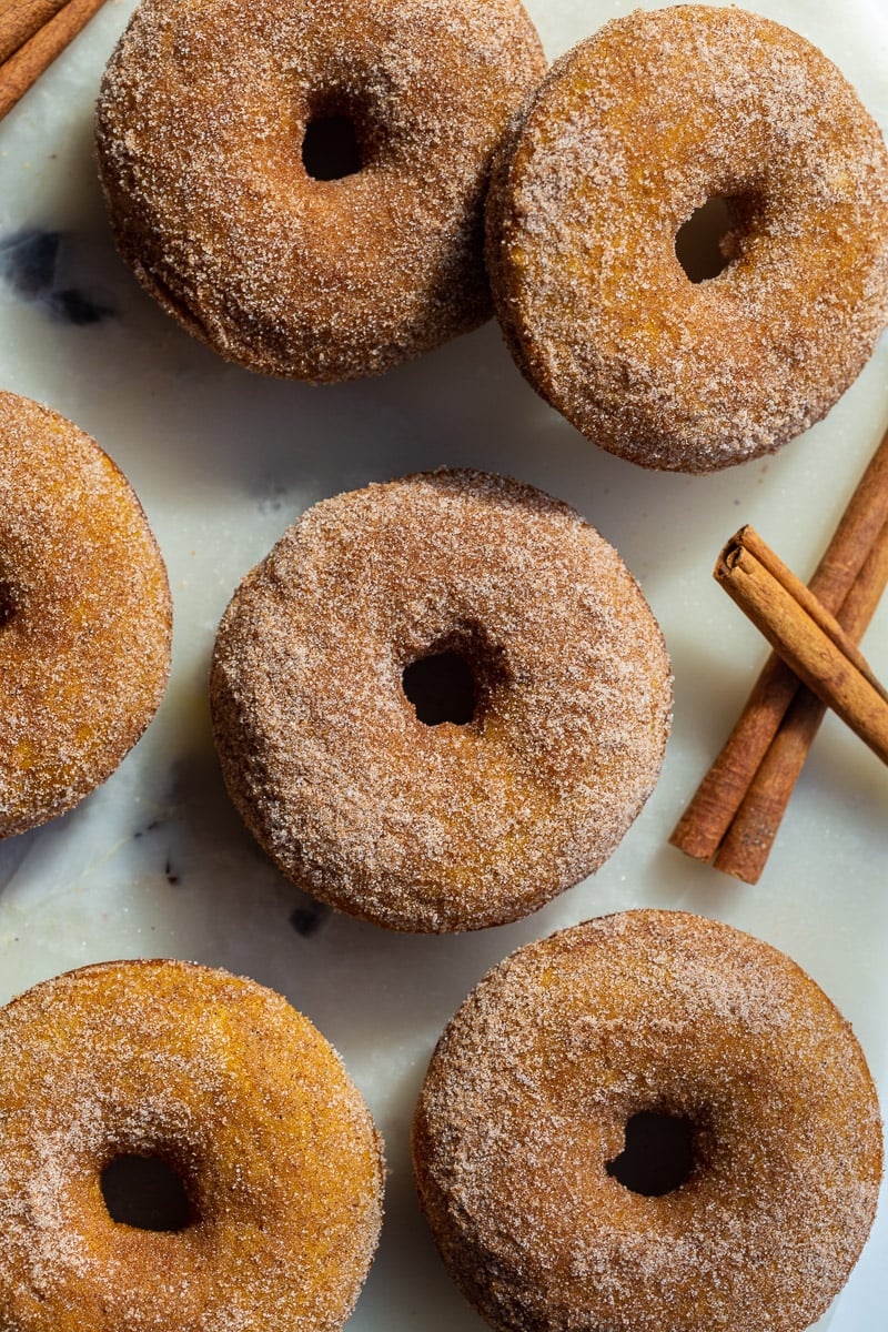 cinnamon sugar baked pumpkin donuts on a tray. 