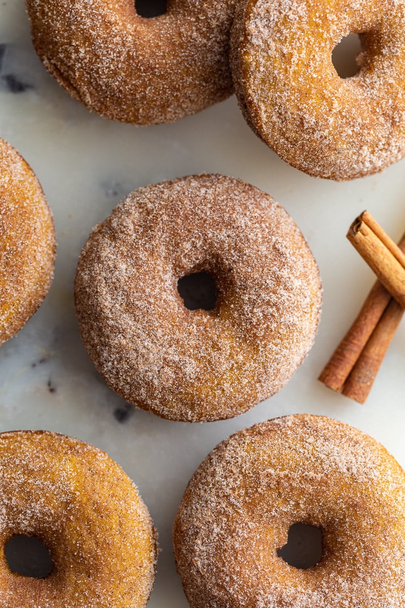 cinnamon sugar baked pumpkin donuts on a tray.