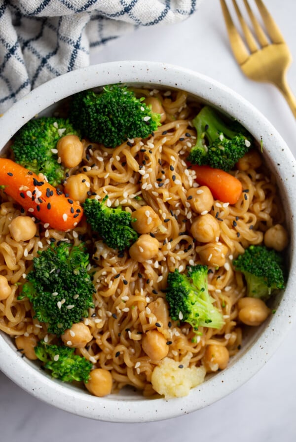 up close shot of ramen noodles with veggies and sprinkled with sesame seeds