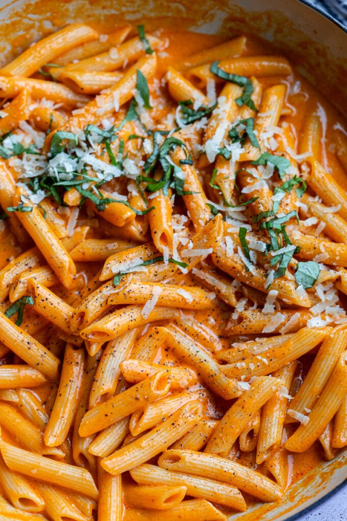 Penne pasta with fresh basil sprinkled over the top.