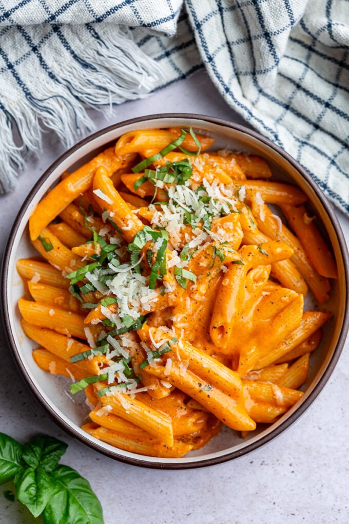 Red pepper pasta in a small bowl.