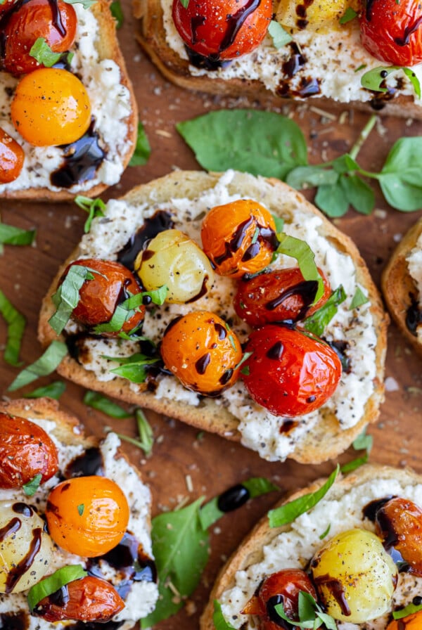 toast topped with ricotta, blistered tomatoes and basil