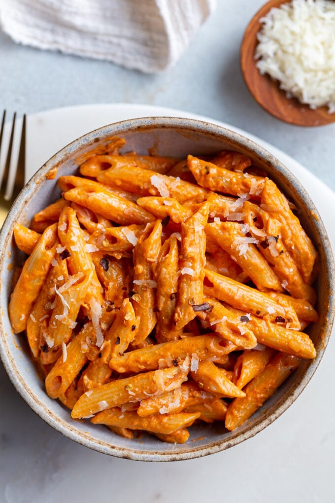 Penne pasta in a tomato sauce served in a bowl.