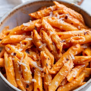 Penne pasta served with rose sauce in a small bowl.