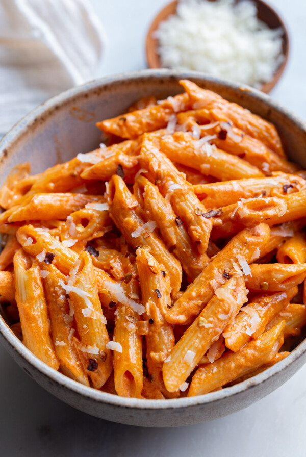 Penne pasta served with rose sauce in a small bowl.