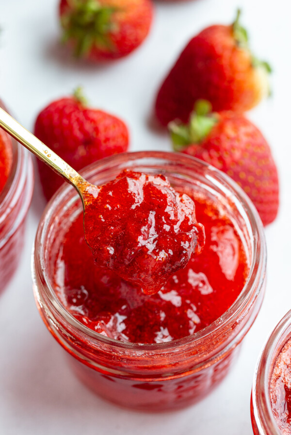 Spooning out strawberry jam.