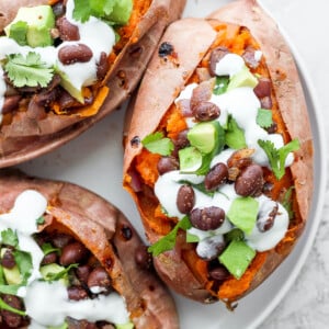 sweet potatoes stuffed with black beans, and avocado and topped with crema