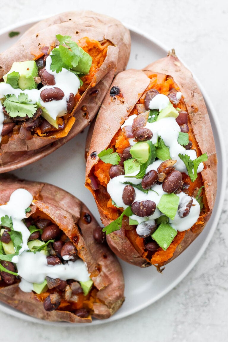 sweet potatoes stuffed with black beans, and avocado and topped with crema