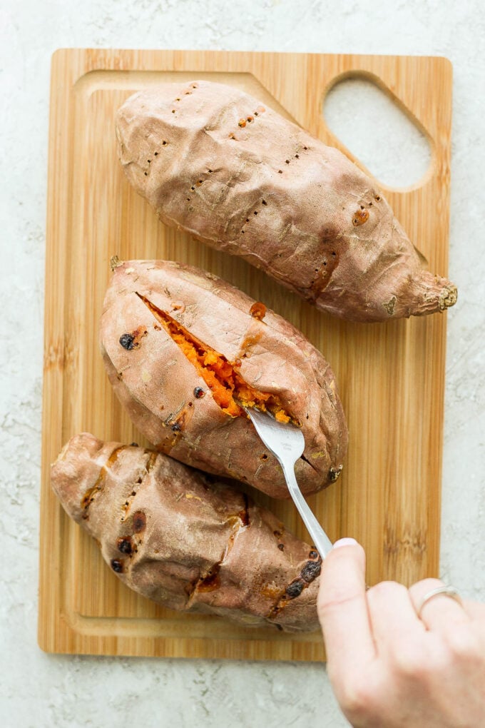 cooked sweet potatoes on a wooden board