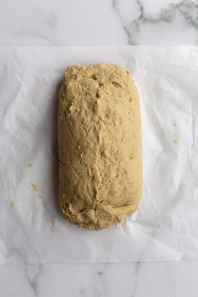 how to make a seitan roast: seitan loaf laying on parchment paper